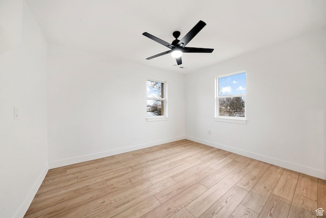 spare room with plenty of natural light, light hardwood / wood-style floors, and ceiling fan