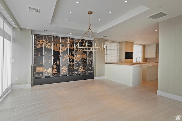 268 S State St E Unit 418, Salt Lake City, UT 84111 - unfurnished dining area with light wood-type flooring and a tray ceiling