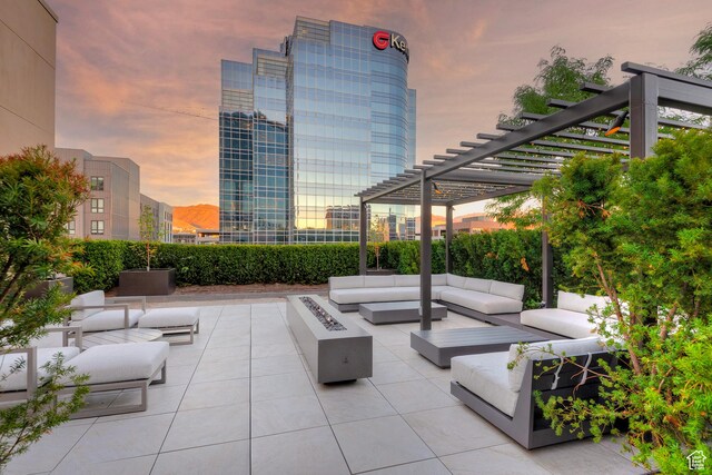 268 S State St E Unit 418, Salt Lake City, UT 84111 - patio terrace at dusk featuring a pergola and an outdoor living space with a fire pit