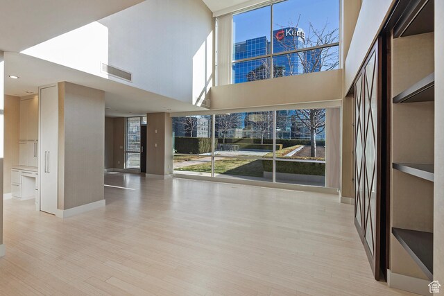 268 S State St E Unit 418, Salt Lake City, UT 84111 - interior space with light hardwood / wood-style flooring and a towering ceiling