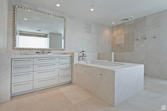 268 S State St E Unit 418, Salt Lake City, UT 84111 - bathroom with tiled bath, tile walls, and vanity