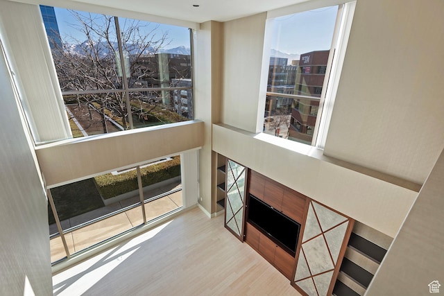 268 S State St E Unit 418, Salt Lake City, UT 84111 - living room featuring a tile fireplace, light hardwood / wood-style flooring, and expansive windows