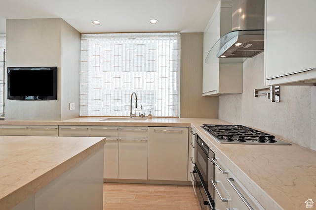 268 S State St E Unit 418, Salt Lake City, UT 84111 - kitchen with light hardwood / wood-style flooring, stainless steel gas stovetop, dishwasher, sink, and island range hood