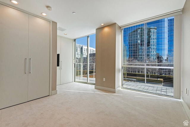 268 S State St E Unit 418, Salt Lake City, UT 84111 - interior space with light colored carpet, a wall of windows, and access to exterior