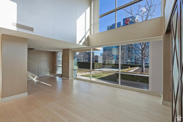 268 S State St E Unit 418, Salt Lake City, UT 84111 - unfurnished room featuring a towering ceiling and light wood-type flooring