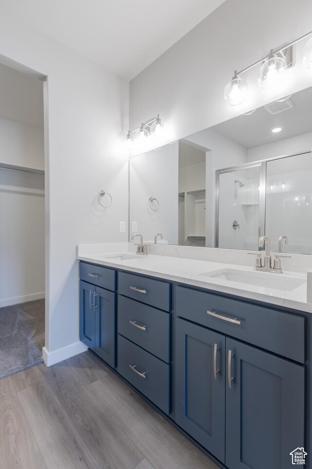 3786 S 4250 W Unit 425, West Haven, UT 84401 - bathroom with double vanity, wood finished floors, a shower stall, and a sink