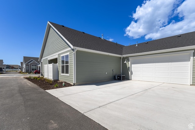 3786 S 4250 W Unit 425, West Haven, UT 84401 - view of side of home featuring driveway, an attached garage, and roof with shingles