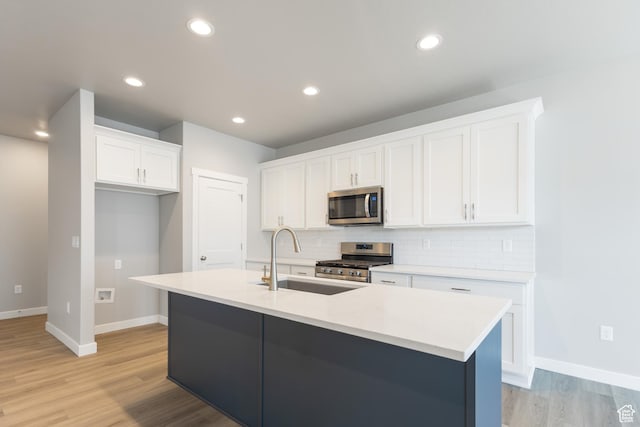 3786 S 4250 W Unit 425, West Haven, UT 84401 - kitchen featuring baseboards, stainless steel appliances, white cabinetry, and a sink