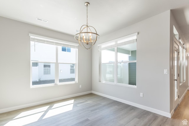 3786 S 4250 W Unit 425, West Haven, UT 84401 - unfurnished room featuring visible vents, light wood-type flooring, a notable chandelier, and baseboards
