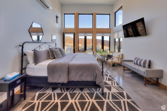 171 E Mt Peale Dr, Moab, UT 84532 - bedroom featuring a towering ceiling, concrete flooring, and an AC wall unit