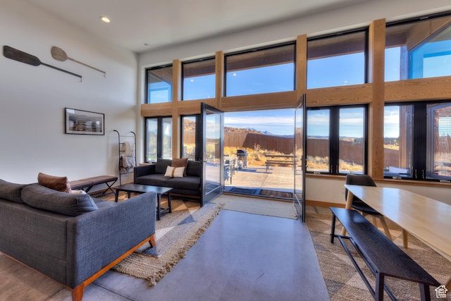 171 E Mt Peale Dr, Moab, UT 84532 - living room with concrete flooring, a towering ceiling, and a wealth of natural light