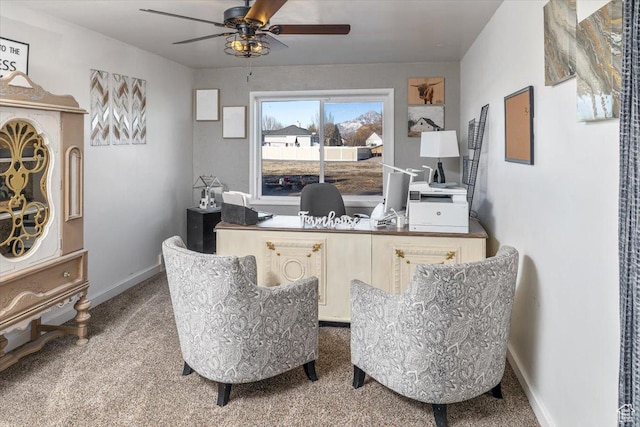 carpeted office space with ceiling fan