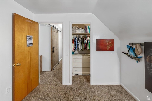 interior space featuring vaulted ceiling and carpet flooring