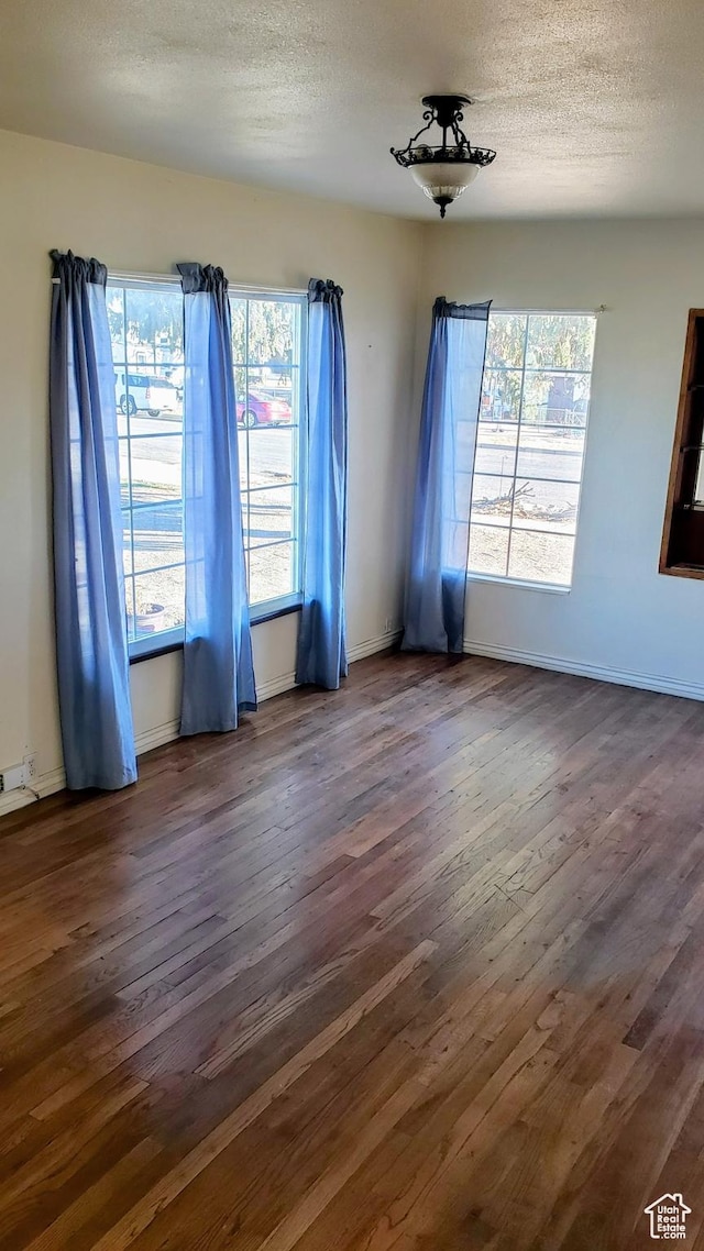 449 E 3rd S, Price, UT 84501 - spare room with dark wood-type flooring, a textured ceiling, and baseboards