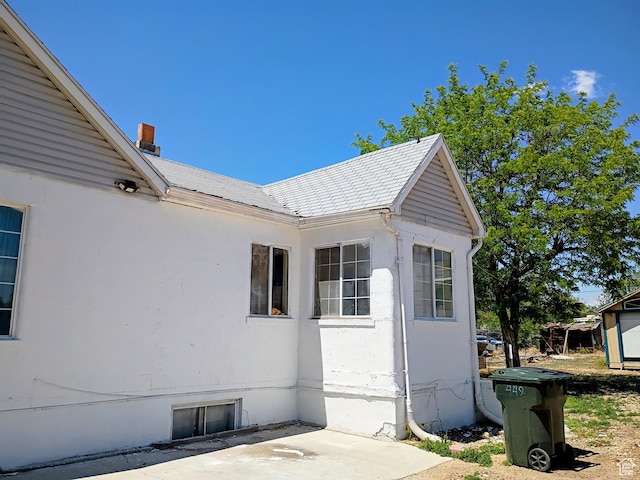 449 E 3rd S, Price, UT 84501 - view of side of home featuring a patio area, a chimney, and stucco siding
