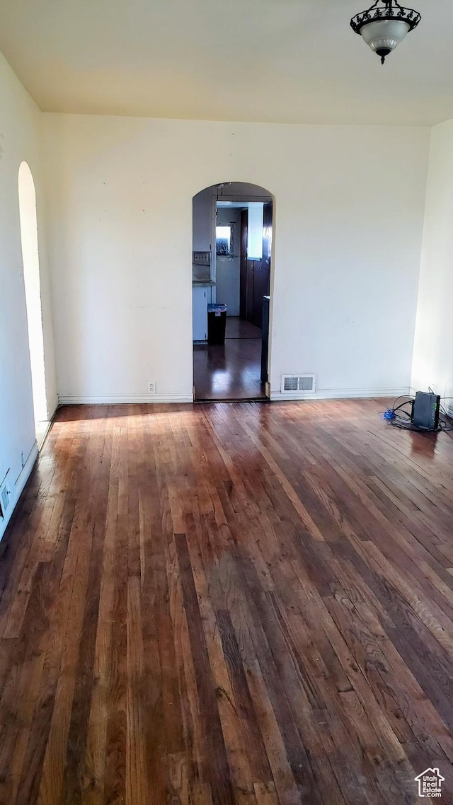 449 E 3rd S, Price, UT 84501 - empty room with arched walkways and hardwood / wood-style floors