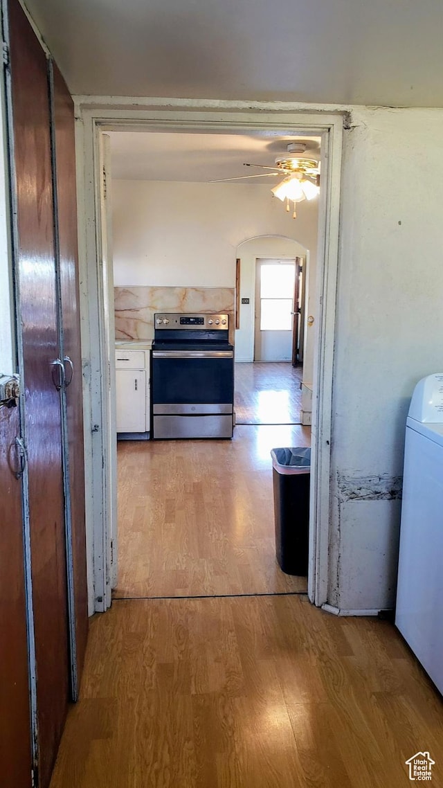 449 E 3rd S, Price, UT 84501 - hall with washer / clothes dryer, light wood-style flooring, and arched walkways