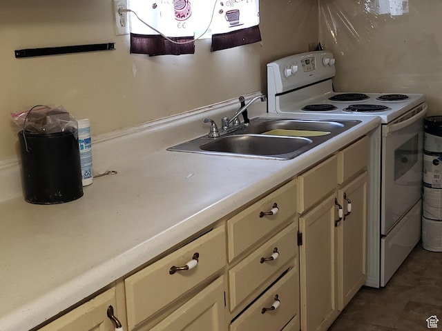kitchen featuring light countertops, white cabinets, a sink, and electric stove