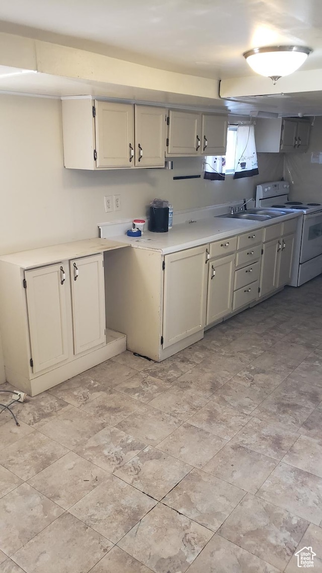 449 E 3rd S, Price, UT 84501 - kitchen featuring white range with electric stovetop, light countertops, and a sink