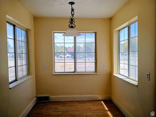 449 E 3rd S, Price, UT 84501 - unfurnished dining area with plenty of natural light, dark wood-style flooring, and baseboards