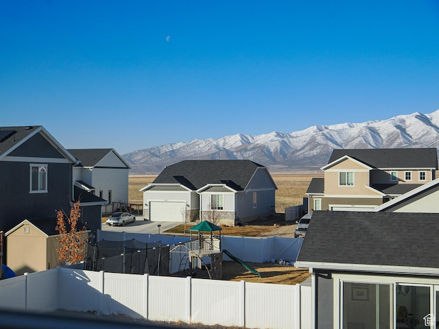 1766 E Johnstown Rd N Unit 710, Eagle Mountain, UT 84005 - view of front of property with fence, a residential view, a mountain view, and a playground