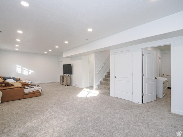 1766 E Johnstown Rd N Unit 710, Eagle Mountain, UT 84005 - unfurnished living room featuring stairway, carpet floors, baseboards, and recessed lighting