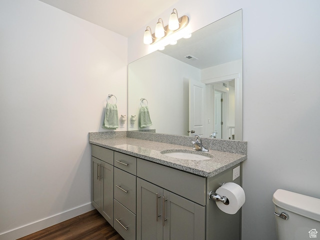 1766 E Johnstown Rd N Unit 710, Eagle Mountain, UT 84005 - bathroom featuring vanity, toilet, baseboards, wood finished floors, and visible vents