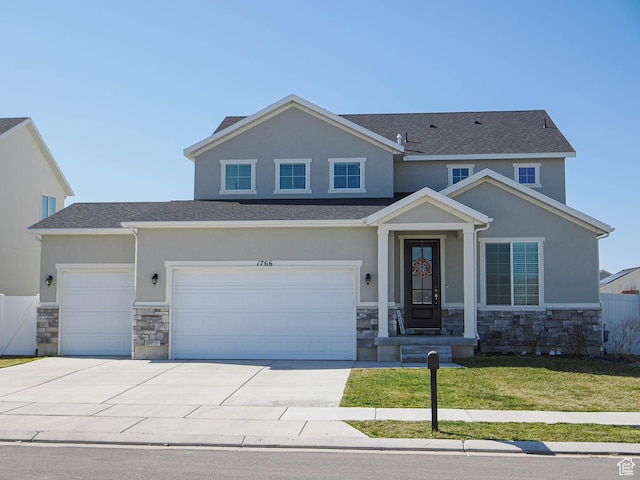 1766 E Johnstown Rd N Unit 710, Eagle Mountain, UT 84005 - view of front of property with fence, stone siding, stucco siding, a front yard, and driveway