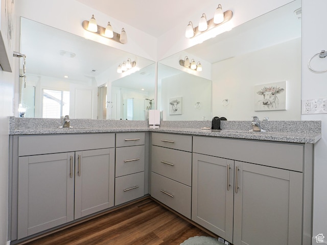 1766 E Johnstown Rd N Unit 710, Eagle Mountain, UT 84005 - full bathroom with double vanity, a sink, wood finished floors, and a shower with door