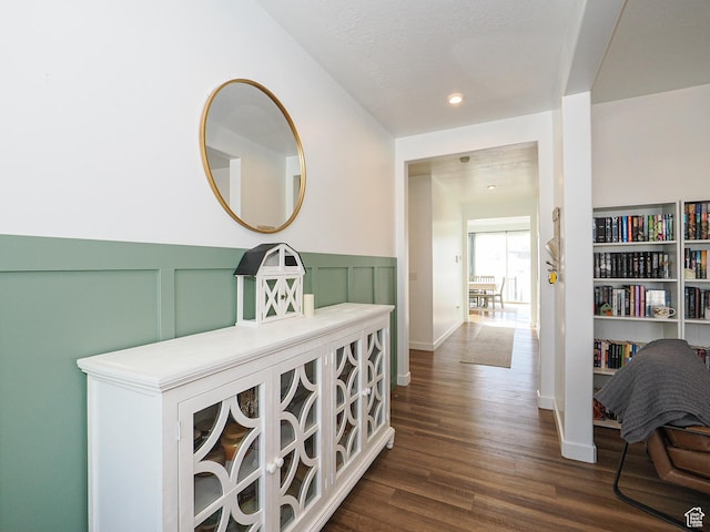 1766 E Johnstown Rd N Unit 710, Eagle Mountain, UT 84005 - hallway featuring a wainscoted wall, a decorative wall, and dark wood finished floors
