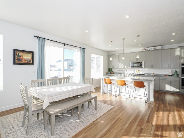 1766 E Johnstown Rd N Unit 710, Eagle Mountain, UT 84005 - dining room featuring recessed lighting, light wood-style flooring, and baseboards