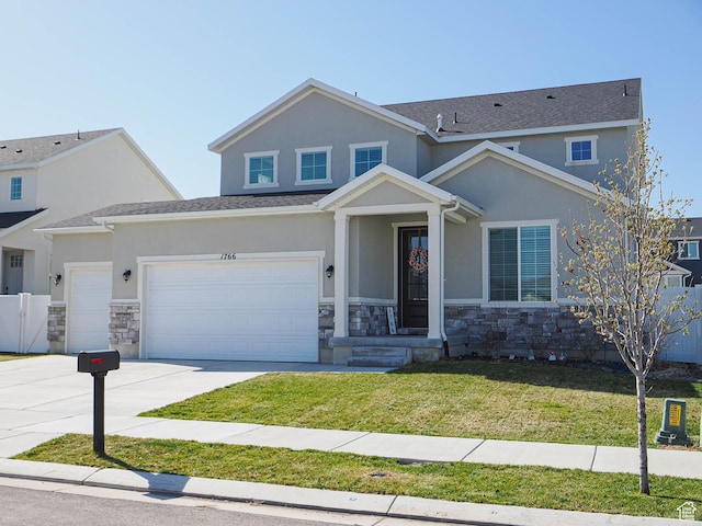 1766 E Johnstown Rd N Unit 710, Eagle Mountain, UT 84005 - view of front of house with stucco siding, a front yard, stone siding, and concrete driveway