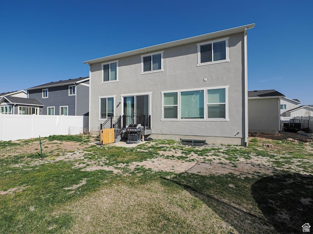 1766 E Johnstown Rd N Unit 710, Eagle Mountain, UT 84005 - rear view of house featuring fence and stucco siding
