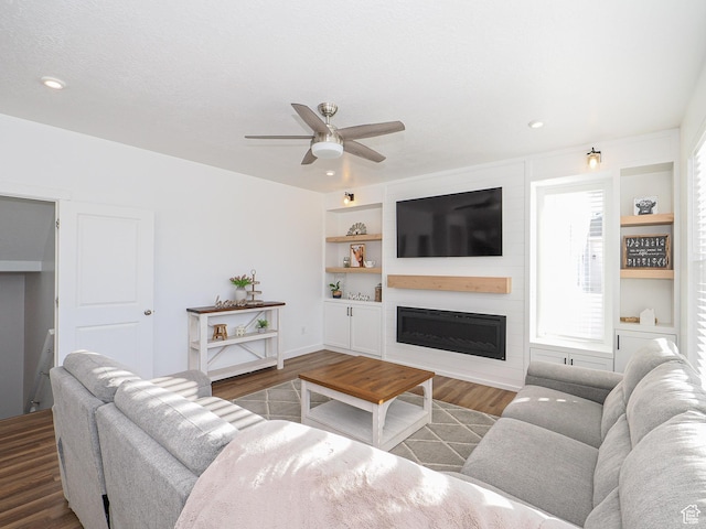 1766 E Johnstown Rd N Unit 710, Eagle Mountain, UT 84005 - living room featuring built in features, wood finished floors, ceiling fan, recessed lighting, and a large fireplace