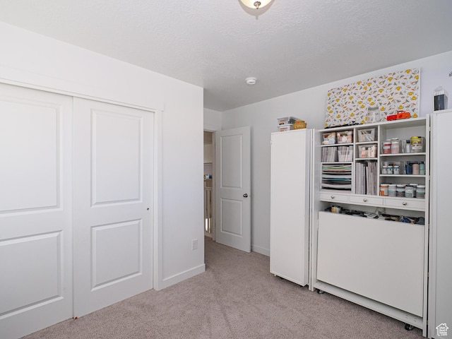 1766 E Johnstown Rd N Unit 710, Eagle Mountain, UT 84005 - unfurnished bedroom featuring a closet, a textured ceiling, baseboards, and light carpet