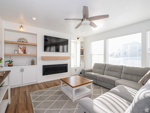 1766 E Johnstown Rd N Unit 710, Eagle Mountain, UT 84005 - living area with a large fireplace, plenty of natural light, a ceiling fan, and wood finished floors