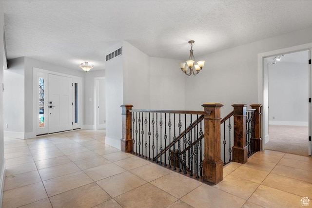 1790 N 120 E, Orem, UT 84057 - entrance foyer featuring light tile patterned floors, a textured ceiling, and an inviting chandelier