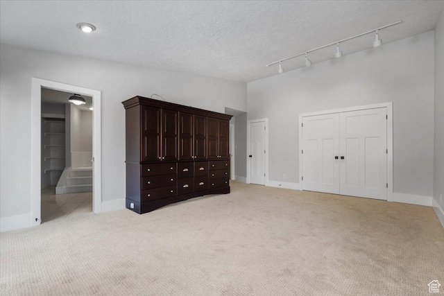 1790 N 120 E, Orem, UT 84057 - unfurnished bedroom featuring two closets, ensuite bath, lofted ceiling, light carpet, and a textured ceiling