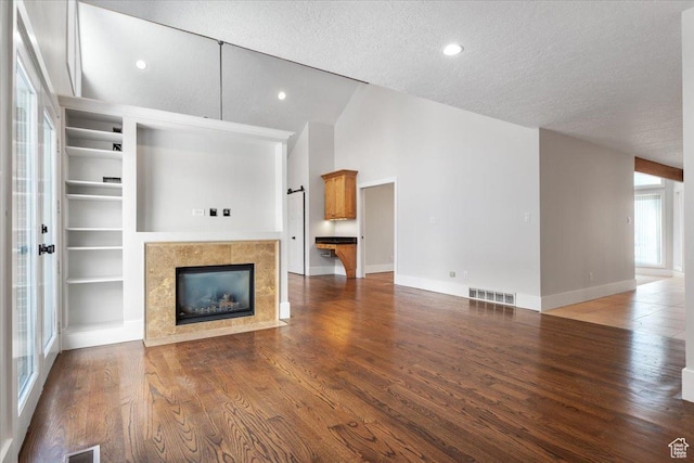 1790 N 120 E, Orem, UT 84057 - unfurnished living room featuring wood-type flooring, high vaulted ceiling, a textured ceiling, and a fireplace