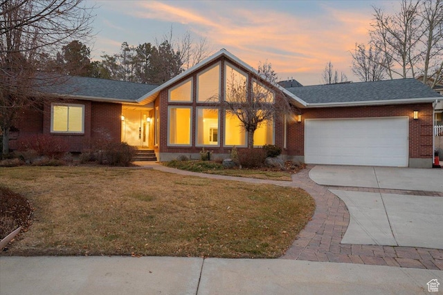 view of front facade with a yard and a garage