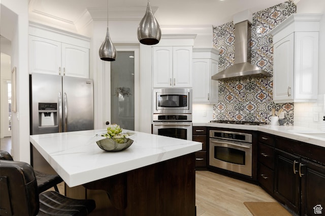 1783 N Firerock Cir, Washington, UT 84780 - kitchen with wall chimney exhaust hood, white cabinetry, stainless steel appliances, a kitchen breakfast bar, and backsplash