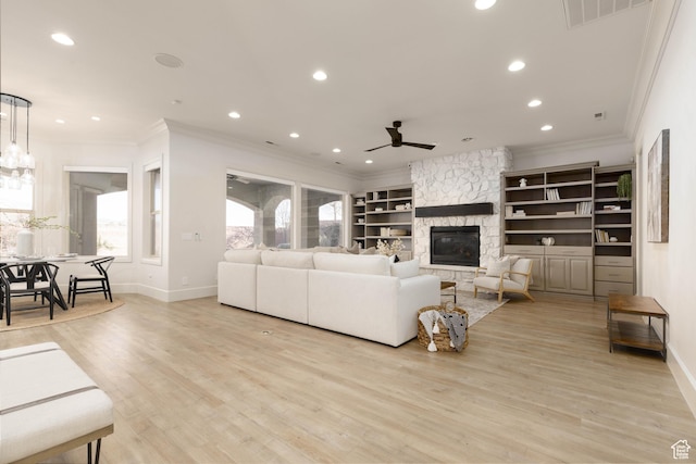 1783 N Firerock Cir, Washington, UT 84780 - living room with a stone fireplace, crown molding, light hardwood / wood-style floors, built in shelves, and ceiling fan