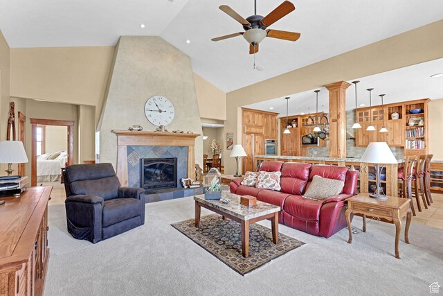 315 S Bear Lake Blvd, Garden City, UT 84028 - living room with high vaulted ceiling, a ceiling fan, light carpet, a tile fireplace, and ornate columns