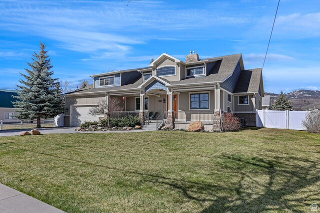 315 S Bear Lake Blvd, Garden City, UT 84028 - view of front facade featuring covered porch, a gate, a garage, a chimney, and driveway