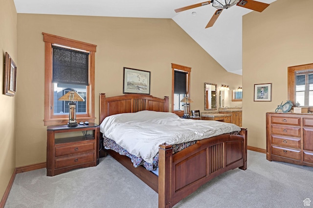 315 S Bear Lake Blvd, Garden City, UT 84028 - bedroom featuring light colored carpet, baseboards, ensuite bath, high vaulted ceiling, and a ceiling fan