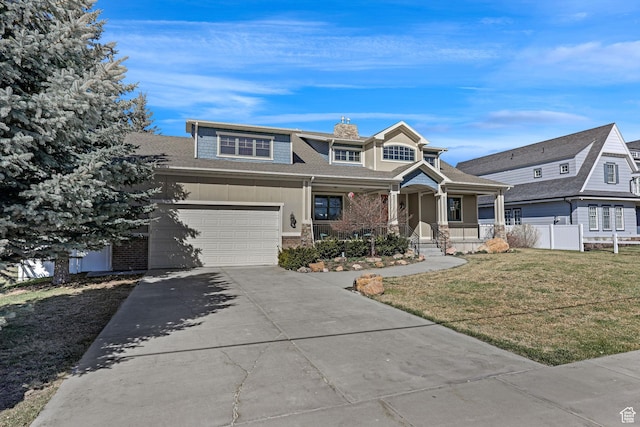 315 S Bear Lake Blvd, Garden City, UT 84028 - view of front of home with covered porch, concrete driveway, a chimney, and brick siding