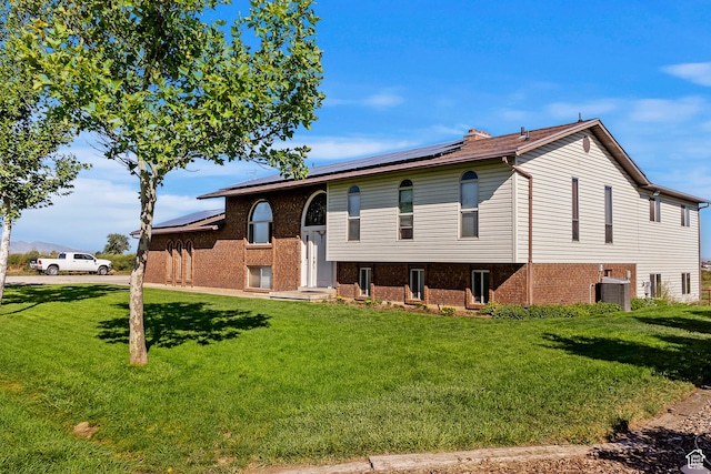 712 S 6150 W, Ogden, UT 84404 - raised ranch with a front yard, central AC unit, and solar panels