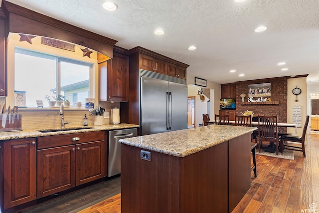 712 S 6150 W, Ogden, UT 84404 - kitchen with sink, stainless steel appliances, a kitchen island, and dark hardwood / wood-style floors
