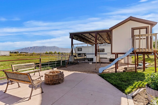 712 S 6150 W, Ogden, UT 84404 - view of patio / terrace with a mountain view and an outdoor fire pit
