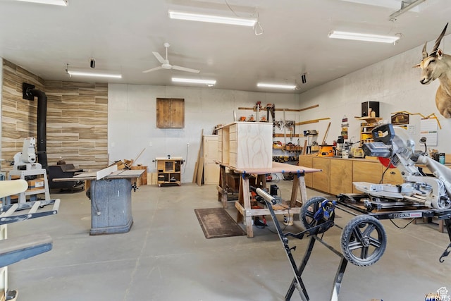 712 S 6150 W, Ogden, UT 84404 - garage featuring ceiling fan, a wood stove, and a workshop area